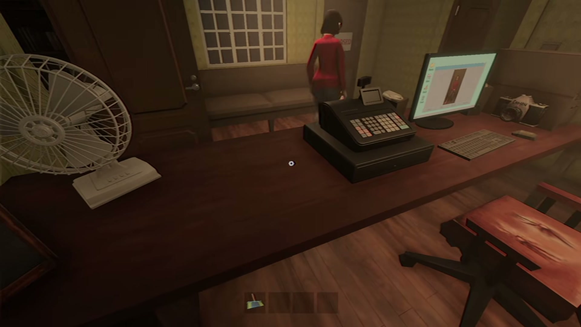 Photomaly gameplay reference frame showing the photography studio workspace with desk, computer, chair, doors, lamps, and counter area.